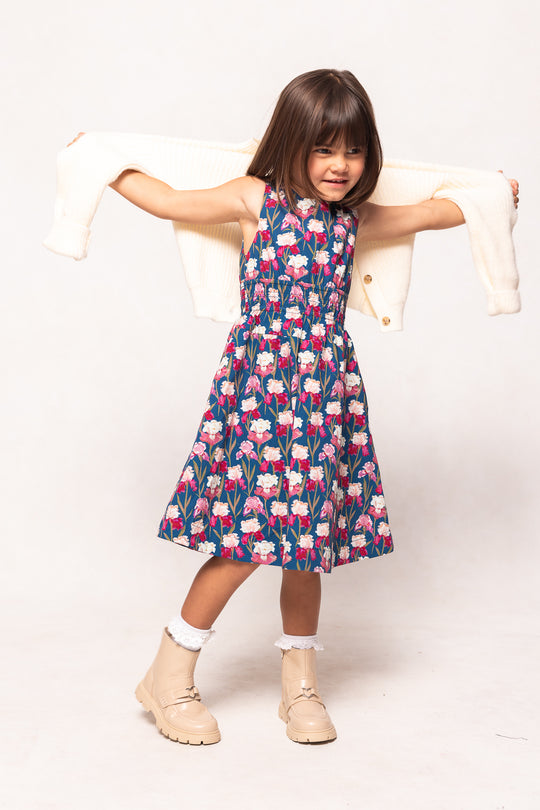 Young girl wearing a floral dress with a white background