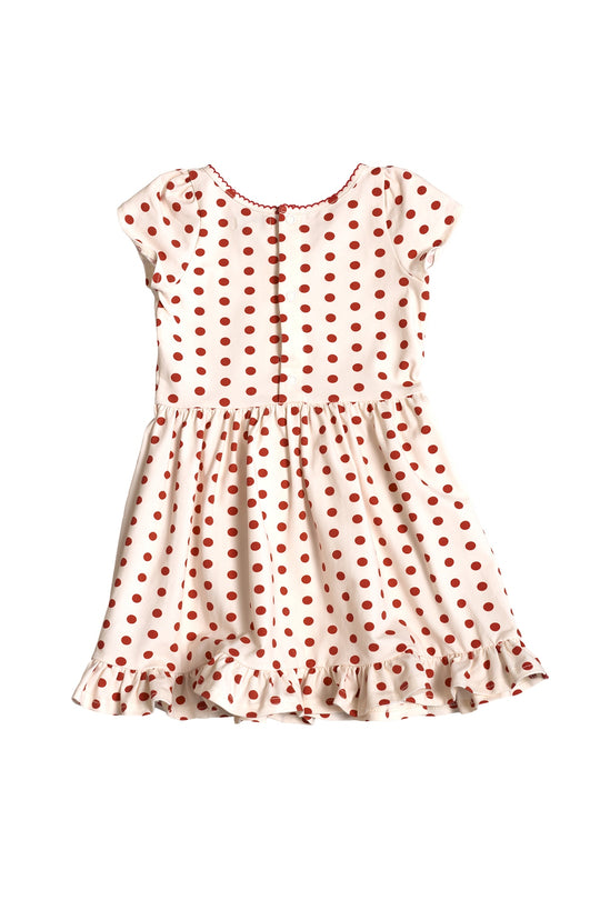 The Ivy City Co Mini Dream Play Dress in Red Polka Dot features short sleeves, a fitted bodice, ruffled hem, round neckline, and center-front buttons—perfect as a girls’ summer dress.