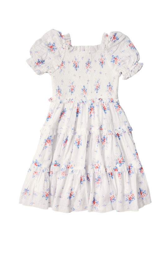 The Mini Emily Dress in Heritage Soft Ditsy Floral by Ivy City Co is a white girls’ mini dress with puffed short sleeves, a smocked bodice, and tiered skirt in pink, blue, and purple florals—perfect for mom and me matching moments.