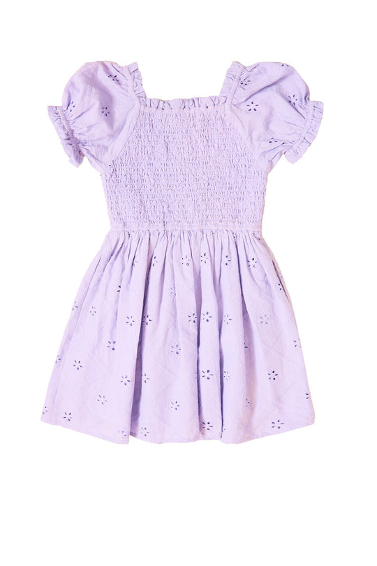 Introducing the Mini Emmi Dress in Lilac by Ivy City Co—a charming light purple toddler dress featuring short puff sleeves, ruffled trim, smocked bodice, and an eyelet floral pattern. This delightful lilac dress is perfect for spring!.