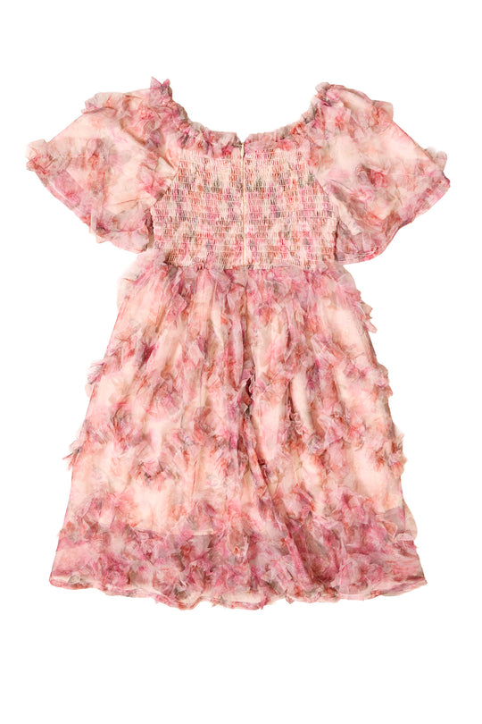 the back of a girls pink floral dress with short sleeves against a white background