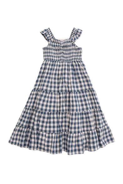The Mini Hailey Dress in Indigo Gingham by Ivy City Co is a sleeveless girls midi dress with ruffled straps, smocked bodice, tiered skirt, and lightweight cotton fabric, shown laid flat on a white background.
