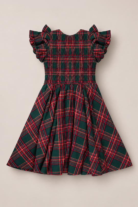 The Mini Hattie Dress in Evergreen Plaid by Ivy City Co features a classic red and green plaid pattern, short ruffled sleeves, a smocked bodice, and a flared skirt. This charming children’s dress is displayed flat on a light background.