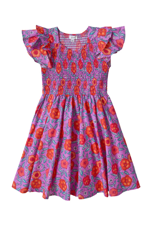 The Ivy City Co Mini Hattie Dress in Thistle Flower Poppy Woodblock is a girls' cotton midi dress featuring ruffled sleeves, a smocked bodice, and a flared, knee-length skirt with a charming red and orange floral pattern.