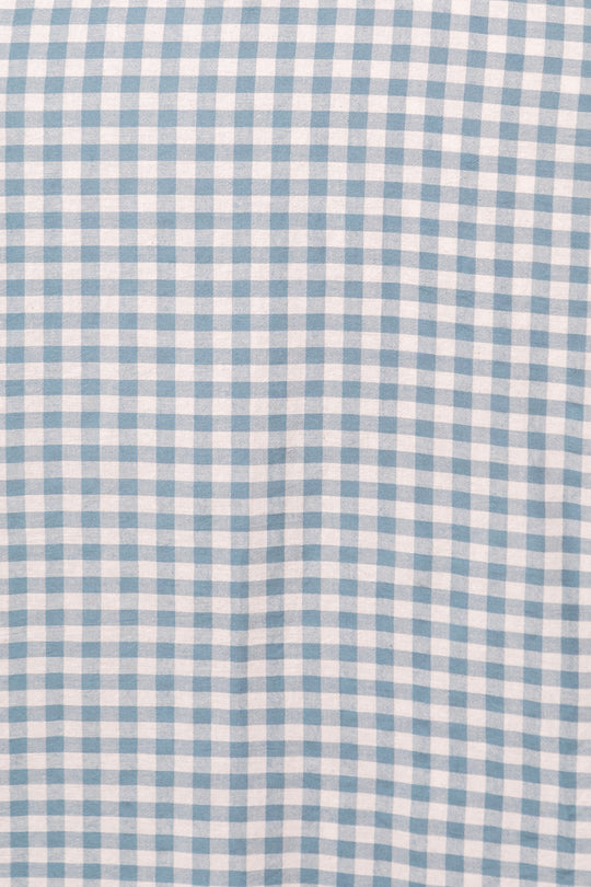 The Hattie Dress in Dusty Teal Gingham by Ivy City Co features a classic checkered pattern—ideal as a comfortable cotton midi dress or a maternity-friendly option.