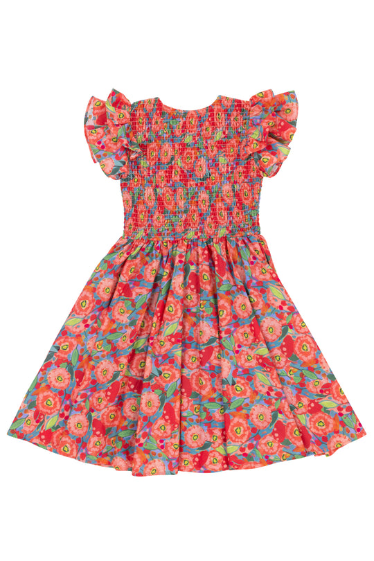 The Mini Hattie Dress in Poppy by Ivy City Co is a colorful girls’ cotton dress with short ruffle sleeves, a smocked bodice, and a vibrant red, pink, green, and yellow poppy pattern. The light flared skirt is comfortable for any occasion.