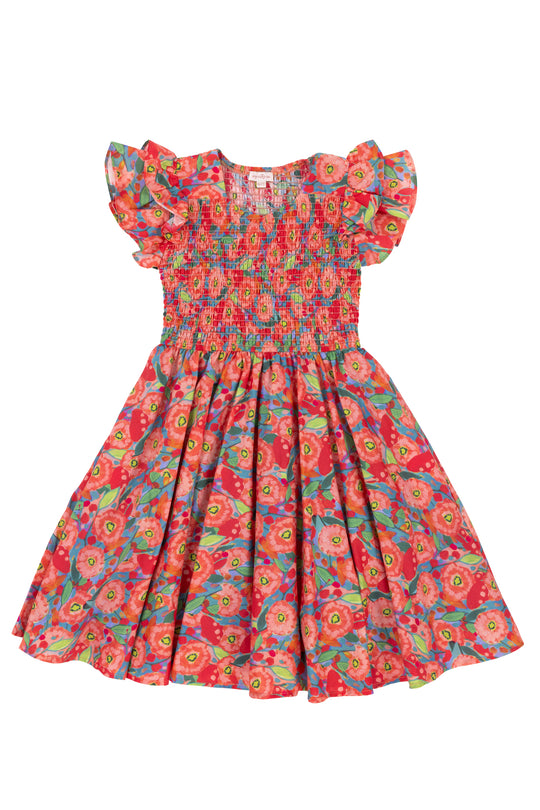 The Ivy City Co Mini Hattie Dress in Poppy features a smocked bodice, ruffled sleeves, and a vibrant poppy-print cotton in red, pink, green, and blue on white with a midi-length skirt.