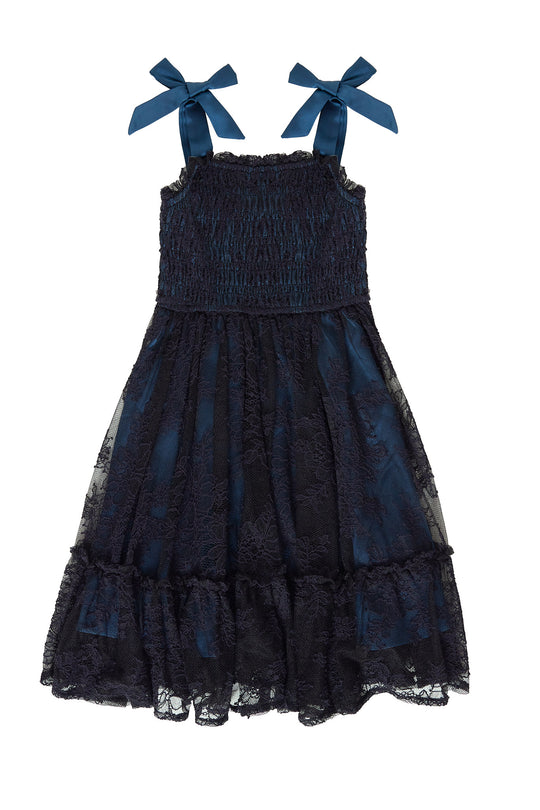 Navy blue dress with bow straps on a white background