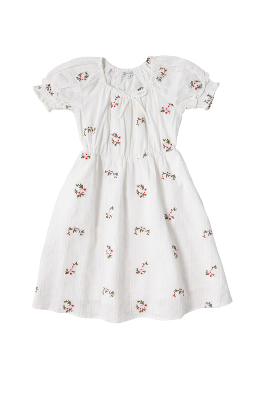 The Mini Jessie Dress in Ditsy Embroidery by Ivy City Co is a white, short-sleeved cotton dress featuring puffed sleeves, a gathered waist, and pink ditsy embroidery for a delicate, vintage-inspired look.