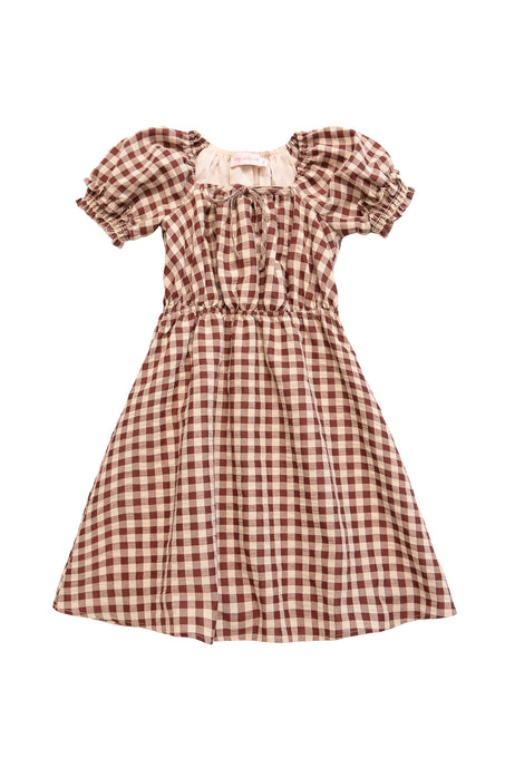 The Ivy City Co Mini Kaitlyn Dress in Chocolate Gingham is a short-sleeved, knee-length dress with puffed sleeves, a gathered waist, and a charming gingham check pattern.