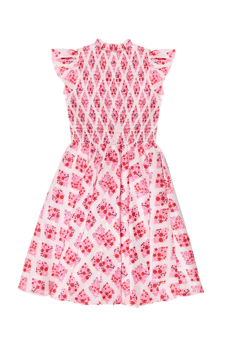 Pink and white patterned dress on a white background
