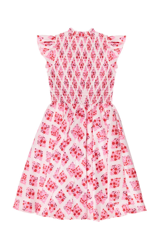 Pink and white patterned dress on a white background