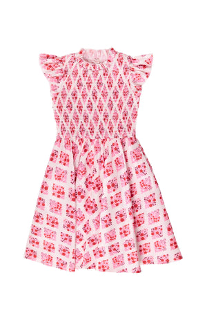 Pink and white patterned dress on a white background