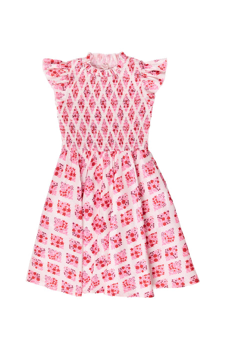 Pink and white patterned dress on a white background