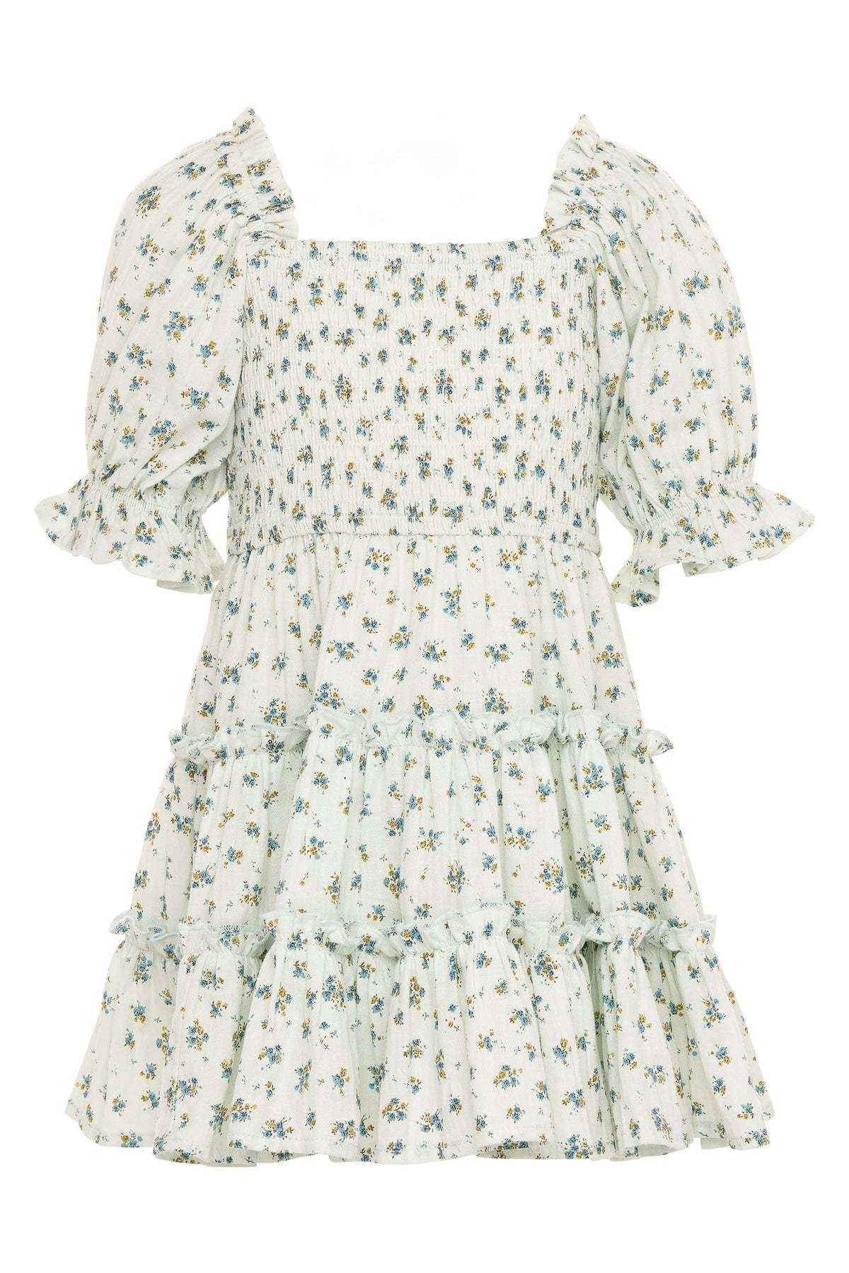 The Mini Madeline Dress in Blue by Ivy City Co is a light-colored, short-sleeved girls’ cotton dress with a square neckline, smocked bodice, puffed sleeves, and a ruffled tiered skirt. It features an allover small blue floral print—making it a charming choice for any occasion.