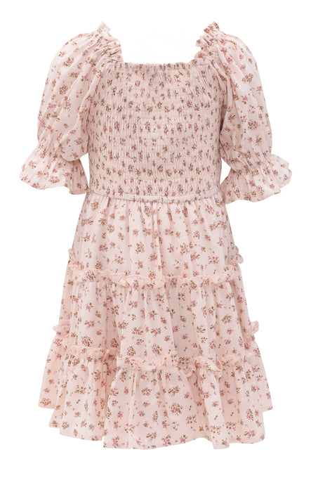 The Mini Madeline Dress in Pink by Ivy City Co features a smocked bodice, puff short sleeves, and a tiered ruffled skirt. Its light pink fabric with floral print and ruffled hem add playful elegance.