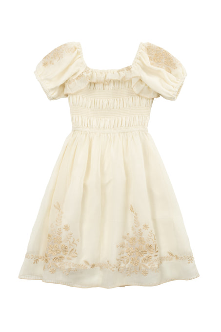 The Mini Mae Dress in Metallic Thread by Ivy City Co features cream-colored fabric, puffed short sleeves, a ruched bodice, and floral embroidery—a soft, vintage-inspired style perfect for matching mom and daughter outfits.