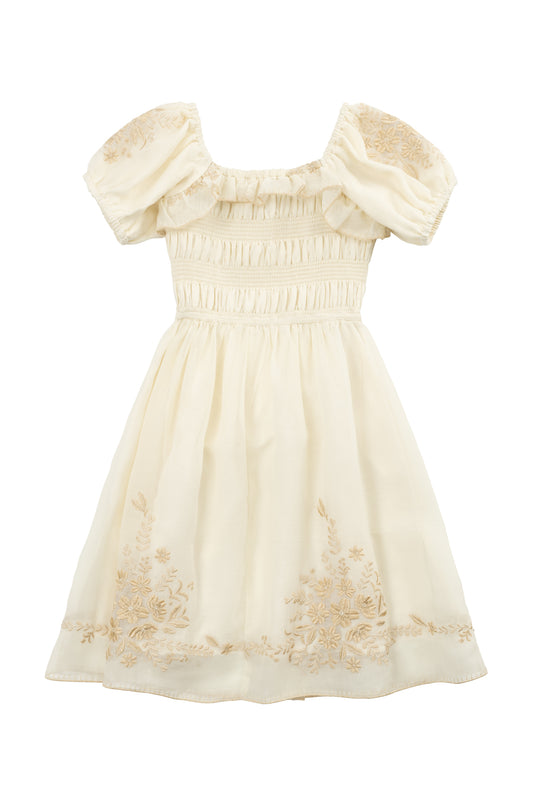 The Mini Mae Dress in Metallic Thread by Ivy City Co features cream-colored fabric, puffed short sleeves, a ruched bodice, and floral embroidery—a soft, vintage-inspired style perfect for matching mom and daughter outfits.