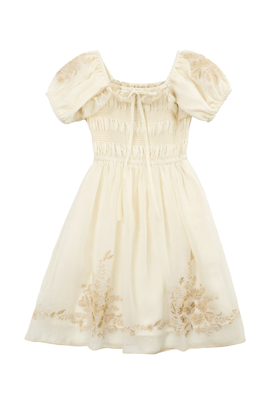 The Mini Mae Dress in Metallic Thread by Ivy City Co features hand embroidery, puffed short sleeves, a gathered bodice with tie, and floral accents—a vintage-inspired cream dress perfect for matching mom and daughter looks.