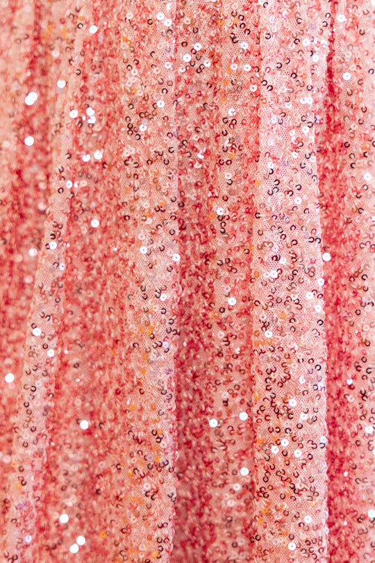 Fabric close up of pink sequin dress