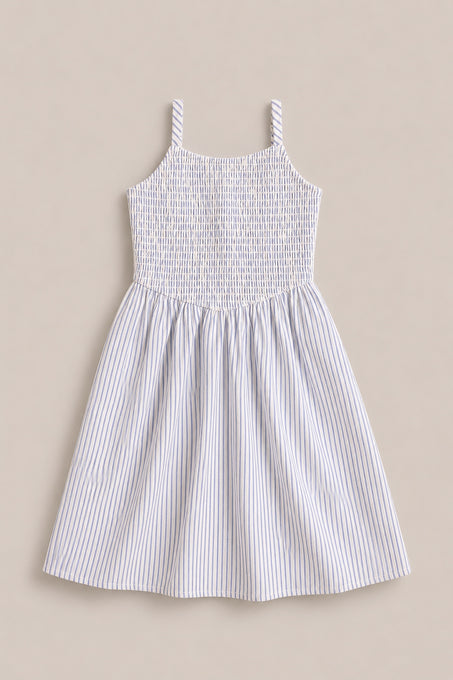 The Mini Maxwell Dress in Blue & White Pinstripe by Ivy City Co features a sleeveless design, smocked bodice, flared skirt, and thin blue stripes—ideal for stylish Mom and Me matching outfits.
