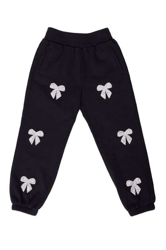 black sweatpants with rhinestone bow detail against a white background
