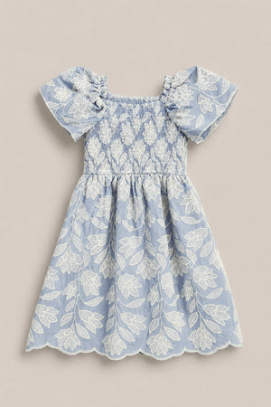 The Mini Ophelia Dress in Mosaic Embroidery by Ivy City Co features a light blue hue, white mosaic embroidery, puffed sleeves, smocked bodice, and scalloped hems. Shown laid flat on a neutral background. Perfect for Mom and Me matching looks.
