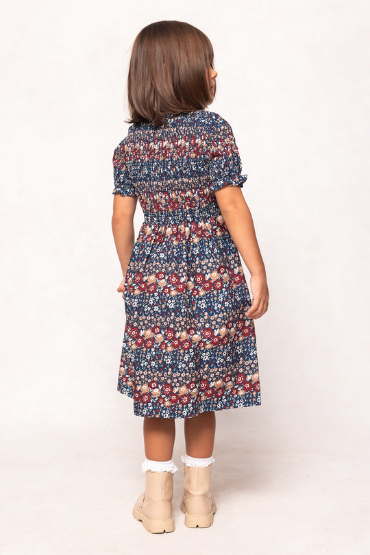 girl wearing a floral dress on a white background