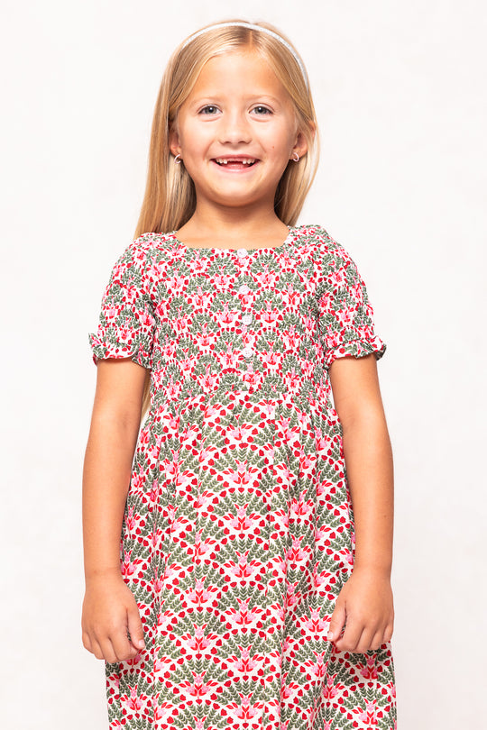 Young girl wearing a floral dress on a white background
