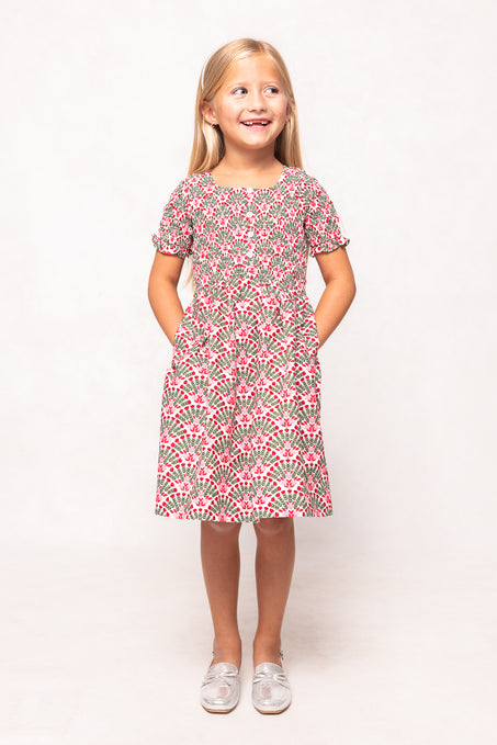 Young girl wearing a pink floral dress on a white background
