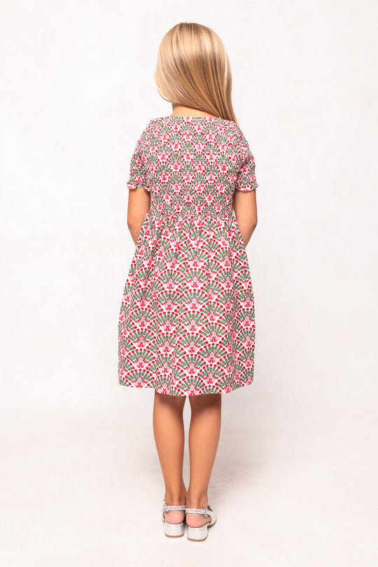 Woman wearing a patterned dress on a white background