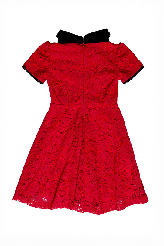 Red lace dress with black trim on a white background