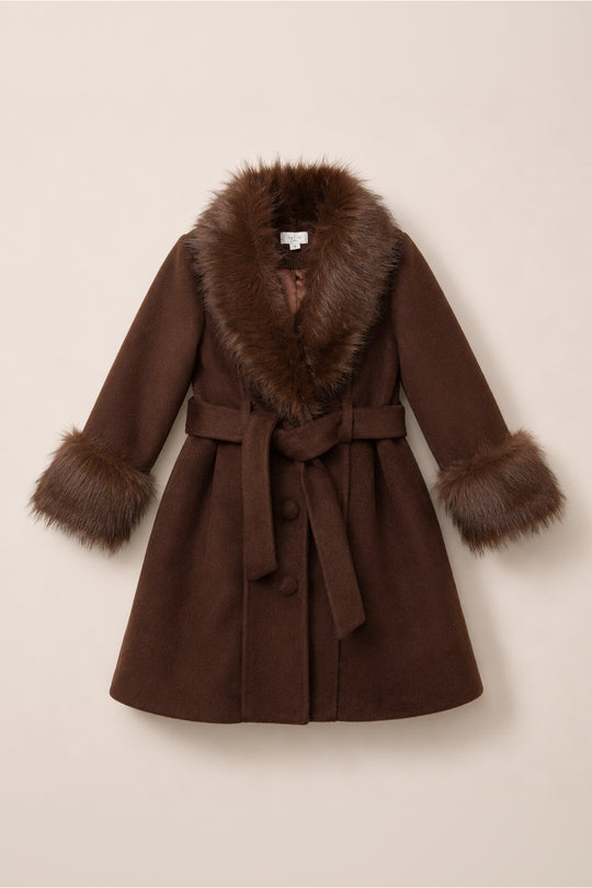 The Mini Pookie Coat in Warm Cocoa by Ivy City Co is a brown wool coat with a wide faux fur collar and cuffs, a matching fabric belt, and large buttons, shown flat on a light beige background—a perfect girls’ fall coat.