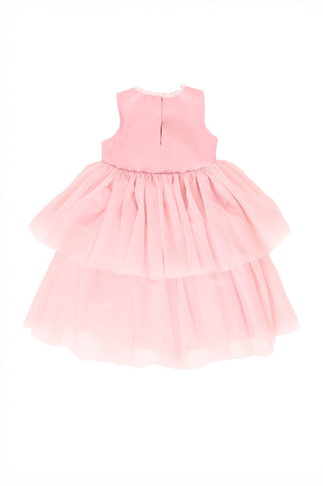 Pink dress with ruffled layers on a white background