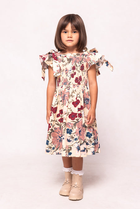 Young girl wearing a floral dress on a white background