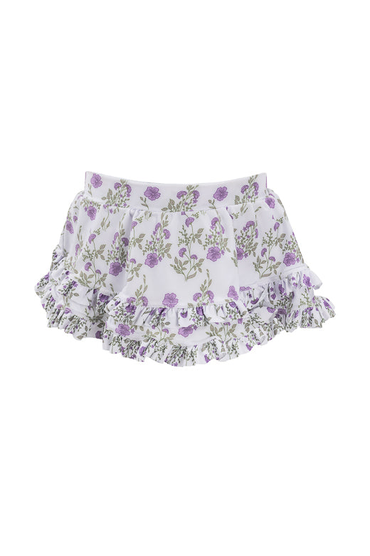 The Ivy City Co Mini Rita Ruffle Skirt in Maeve Floral features white fabric with an all-over purple rose print and a flouncy ruffled hem, shown against a plain white background.