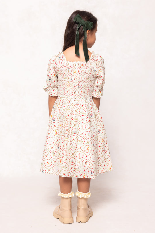 Young girl wearing a floral dress with a plain background
