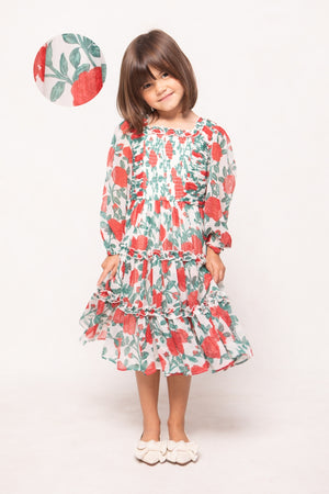 Young girl wearing a floral dress with a white background