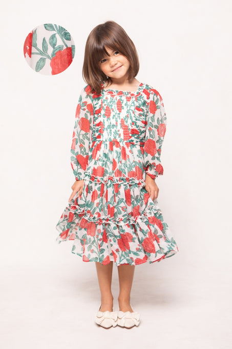 Young girl wearing a floral dress with a white background