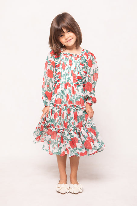 Young girl wearing a floral dress on a white background