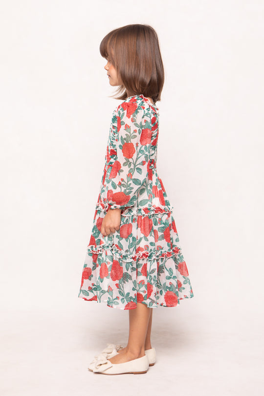Young girl wearing a floral dress on a white background