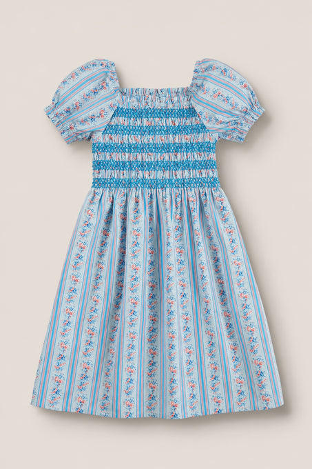 The Mini Sunday Best Dress in Rosette Linear Stripe by Ivy City Co features puff sleeves, a smocked bodice, and a gathered skirt with pink and white floral patterns—ideal for Mom and Me matching moments.