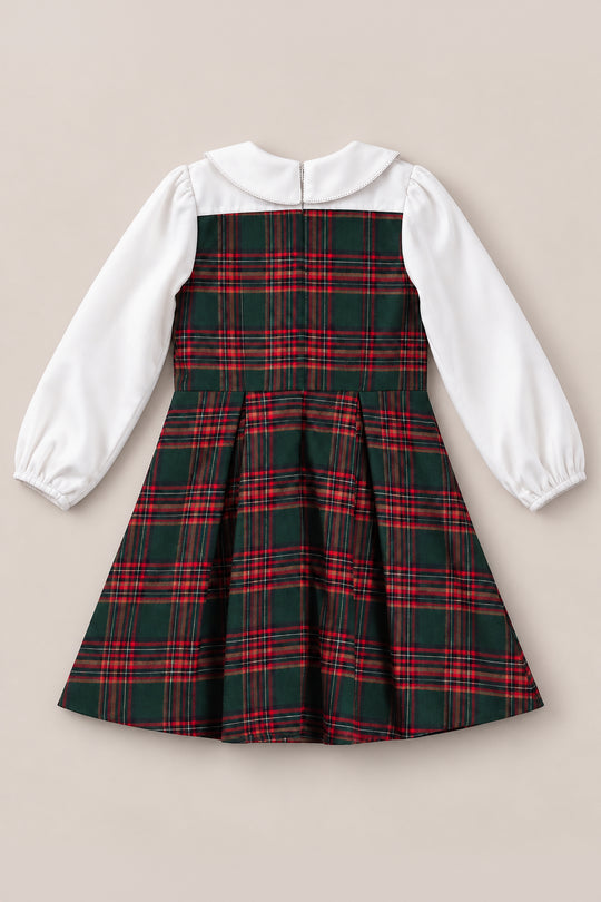 The Mini Tawny Dress in Evergreen Plaid by Ivy City Co features classic white long sleeves, a crisp white collar, and a festive green and red plaid pattern on the bodice and skirt. With its fitted waist and convenient back zipper for easy dressing, this dress is perfect for holiday portraits or as a Christmas dress.