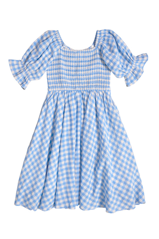 The Mini Teagan Dress in Blue Gingham by Ivy City Co features short puffed sleeves, a smocked bodice, and a flared skirt—perfect as a girls' spring dress. Shown flat on a white background.