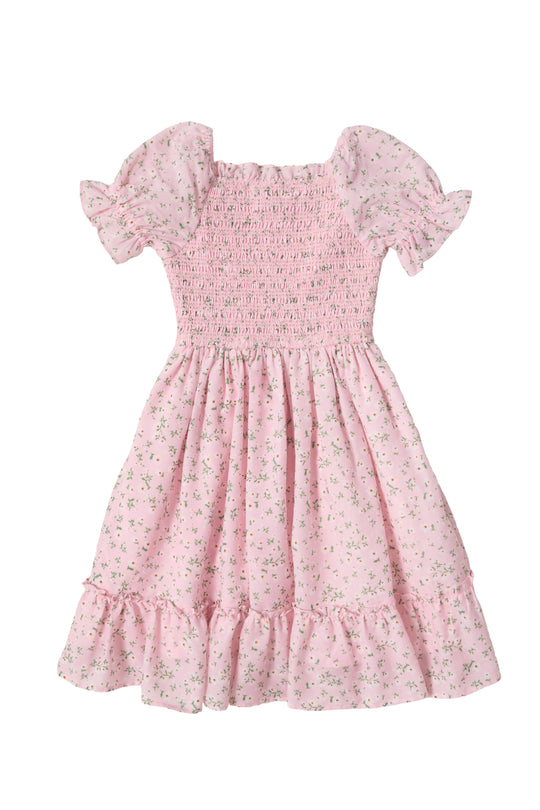 The Mini Valencia Dress in Pink Ditsy Floral by Ivy City Co is a girls' midi dress with short sleeves, a smocked bodice, ruffled hem, and charming green floral print shown laid flat on a white background.