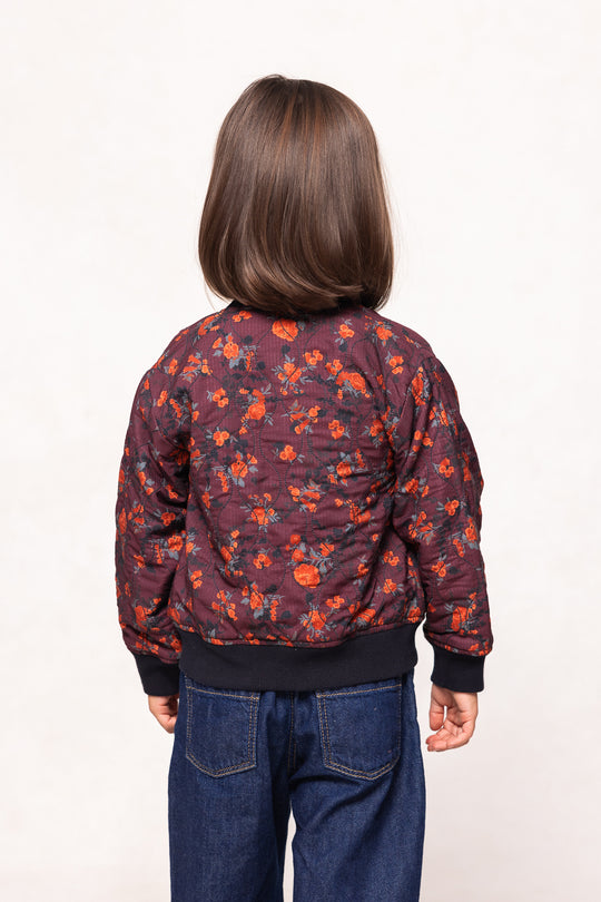 Person wearing a floral-patterned jacket on a white background