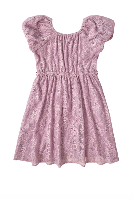 The Mini Kiara Dress in Hyssop Lace by Ivy City Co features dusty purple floral lace, short puff sleeves, a gathered waist, and a soft, feminine look. This girls’ party dress is shown on a white background.
