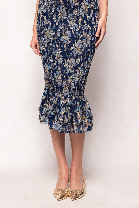 Navy floral dress with ruffled hem on a white background