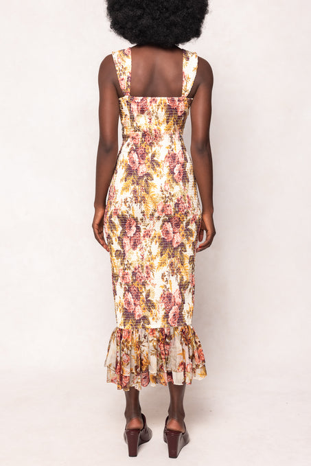 Woman wearing a floral dress with a plain background