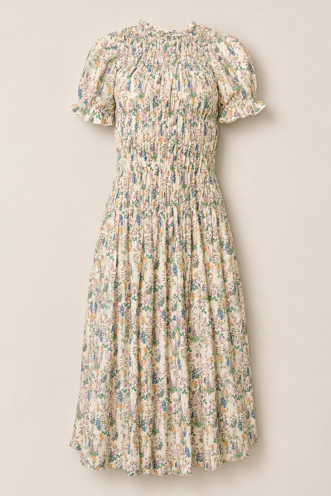 The Jennifer Dress in Autumn Bouquet by Ivy City Co is a floral midi dress featuring short puff sleeves, a smocked bodice, and a flowy skirt. Designed with a multicolored pastel flower print on a light background, this maternity-friendly dress combines style and comfort for any occasion.